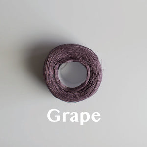 A 'Grape' colour yarn cake of 2/16s mercerised cotton yarn