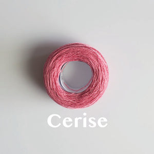 A 'Cerise' colour yarn cake of 2/16s mercerised cotton yarn