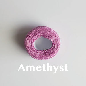 An 'Amethyst' colour yarn cake of 2/16s mercerised cotton yarn