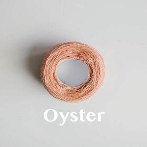 A 'Oyster' colour yarn cake of 2/16s mercerised cotton yarn