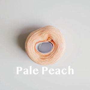 A 'Pale Peach' colour yarn cake of 2/16s mercerised cotton yarn