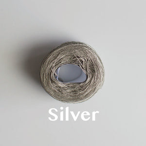 A 'Silver' colour yarn cake of 2/16s mercerised cotton yarn