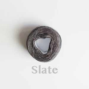 A 'Slate' colour yarn cake of 2/16s mercerised cotton yarn
