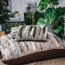 Load image into Gallery viewer, Two richly-textured handwoven cushions featuring wool roving woven in the Soumak pattern, sitting in front of a Christmas tree, gifts and a monstera plant