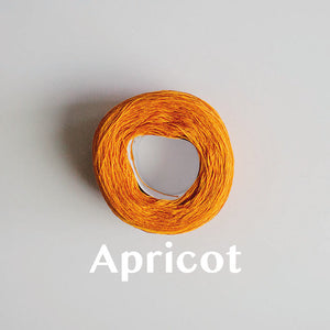 A 'Apricot' colour yarn cake of 2/16s mercerised cotton yarn