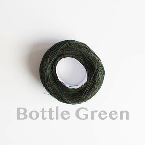 A 'Bottle Green' colour yarn cake of 2/16s mercerised cotton yarn