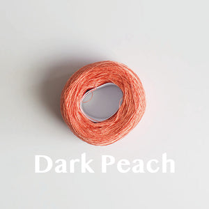 A 'Dark Peach' colour yarn cake of 2/16s mercerised cotton yarn