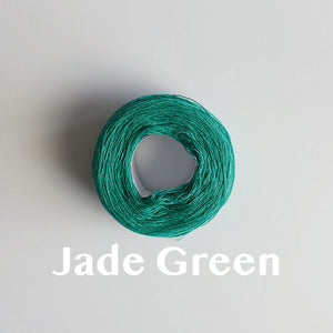 A 'Jade Green' colour yarn cake of 2/16s mercerised cotton yarn