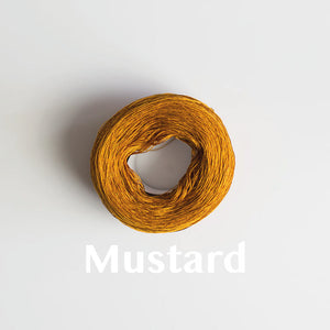 A 'Mustard' colour yarn cake of 2/16s mercerised cotton yarn
