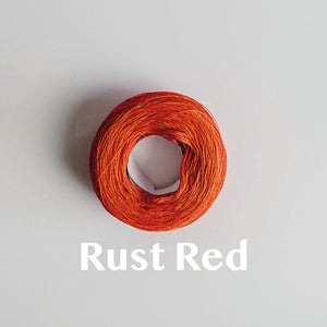 A 'Rust Red' colour yarn cake of 2/16s mercerised cotton yarn