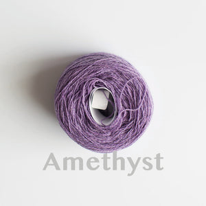 An 'Amethyst' colour yarn cake of 2/17s merino lambswool yarn