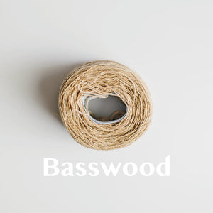 A 'Basswood' colour yarn cake of 2/17s merino lambswool yarn