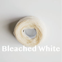 Load image into Gallery viewer, A &#39;Bleached White&#39; colour yarn cake of 2/17s merino lambswool yarn