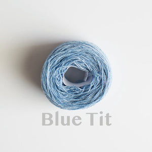 A 'Blue Tit' colour yarn cake of 2/17s merino lambswool yarn