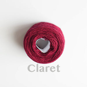 A 'Claret' colour yarn cake of 2/17s merino lambswool yarn