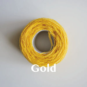 A 'Gold' colour yarn cake of 2/17s merino lambswool yarn