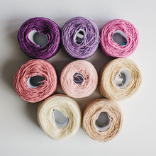 Load image into Gallery viewer, A group of  rainbow-coloured yarn cakes of 2/17s merino lambswool yarn in pinks, purples and neutrals