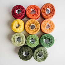 Load image into Gallery viewer, A group of  rainbow-coloured yarn cakes of 2/17s merino lambswool yarn in reds, orange, yellow and green