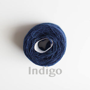 An 'Indigo' colour yarn cake of 2/17s merino lambswool yarn