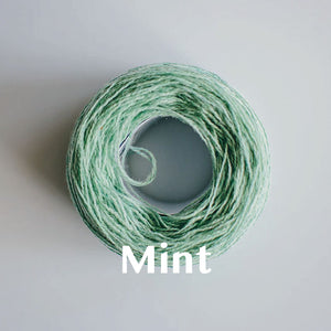 A 'Mint' colour yarn cake of 2/17s merino lambswool yarn