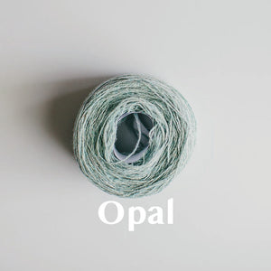 An 'Opal' colour yarn cake of 2/17s merino lambswool yarn