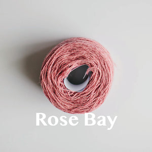 A 'Rose Bay' colour yarn cake of 2/17s merino lambswool yarn