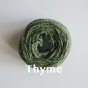 A 'Thyme' colour yarn cake of 2/17s merino lambswool yarn