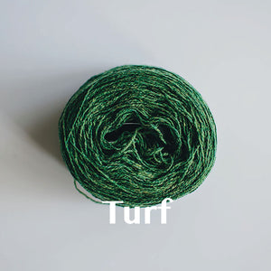A 'Turf' colour yarn cake of 2/17s merino lambswool yarn
