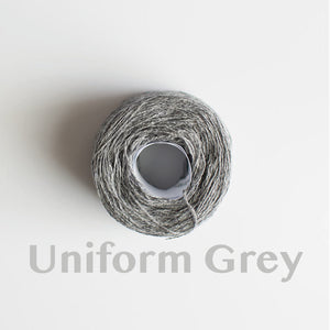 A 'Uniform Grey' colour yarn cake of 2/17s merino lambswool yarn