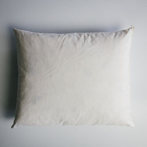 A rectangular 13 inch by 17 inch duck-filled cushion pad covered in cotton cambray fabric.