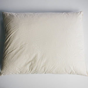 A rectangular 18 inch by 24 inch duck-filled cushion pad covered in cotton cambray fabric.