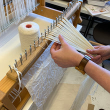 Load image into Gallery viewer, Close up image of a student learning how to raddle a warp on a table loom at Tools used in a Private Weaving workshop at The Oxford Weaving Studio