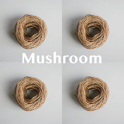 Four yarn cakes of 4-ply mercerised cotton yarn in mushroom packaged in a compostable plastic bag and an Oxford Weaving Studio sticker