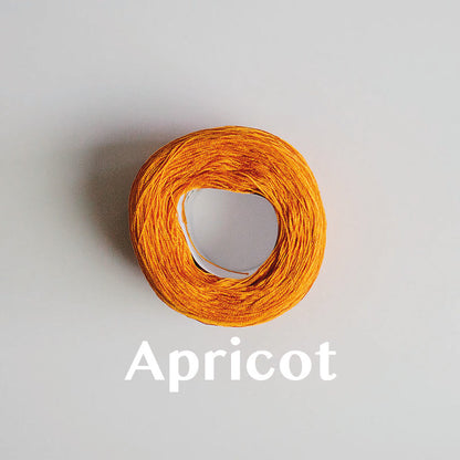 A 'Apricot' colour yarn cake of 2/16s mercerised cotton yarn