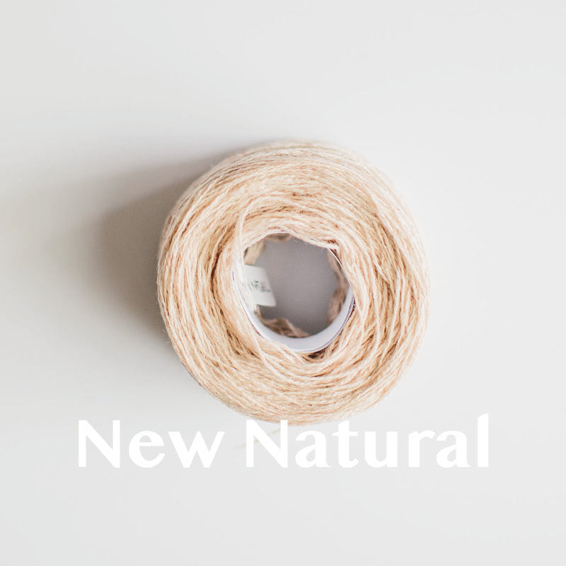 A 'New Natural' colour yarn cake of 2/17s merino lambswool yarn