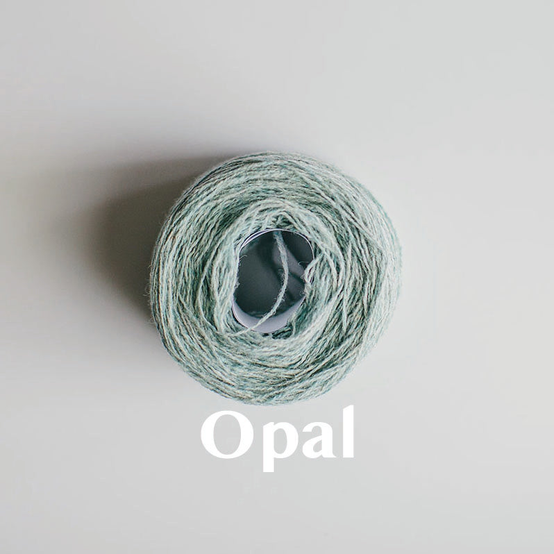 An 'Opal' colour yarn cake of 2/17s merino lambswool yarn